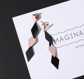 Long string of geometric diamond pendants